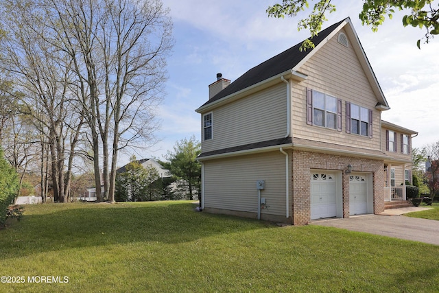 view of side of property featuring aphalt driveway, brick siding, a yard, a garage, and a chimney