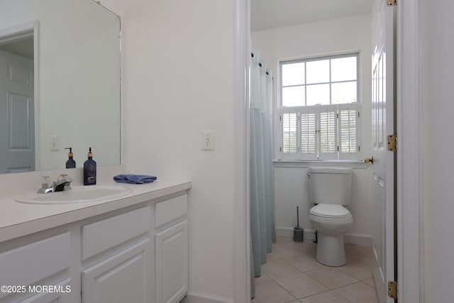 bathroom featuring tile patterned flooring, toilet, and vanity