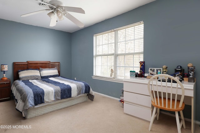 carpeted bedroom with ceiling fan and baseboards