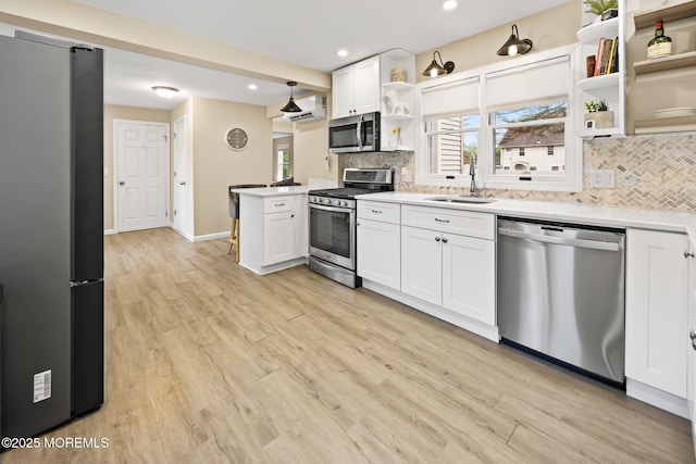 kitchen with backsplash, open shelves, appliances with stainless steel finishes, and a sink