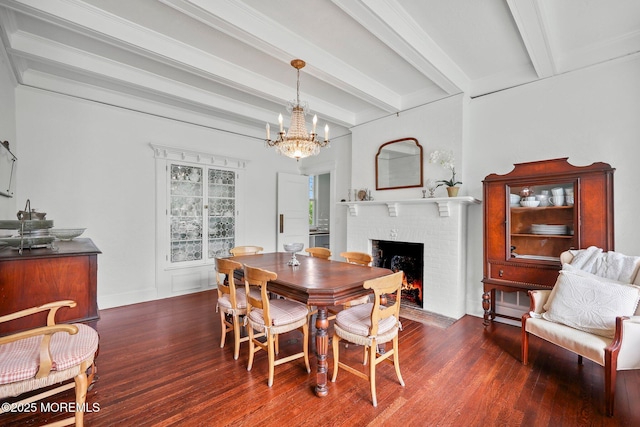 dining space with beam ceiling, wood finished floors, and a brick fireplace