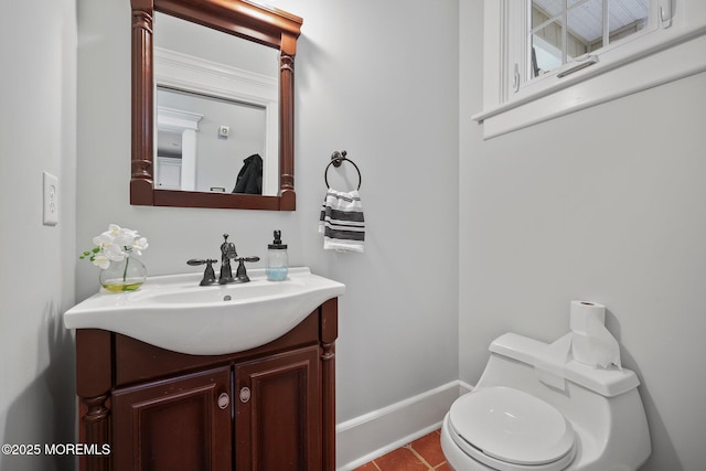 bathroom featuring toilet, baseboards, tile patterned flooring, and vanity