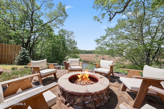view of patio / terrace featuring a fire pit and fence
