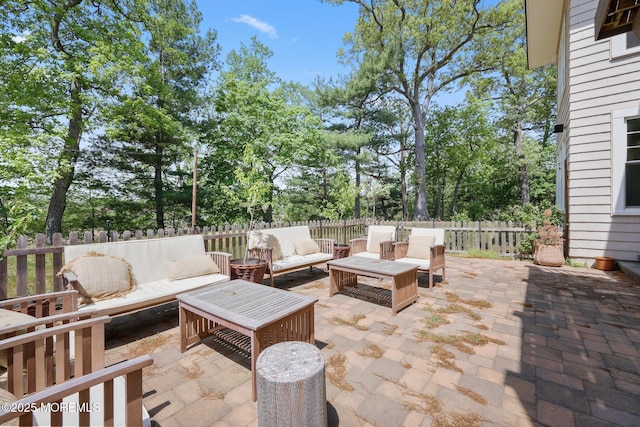 view of patio / terrace featuring an outdoor hangout area and a fenced backyard