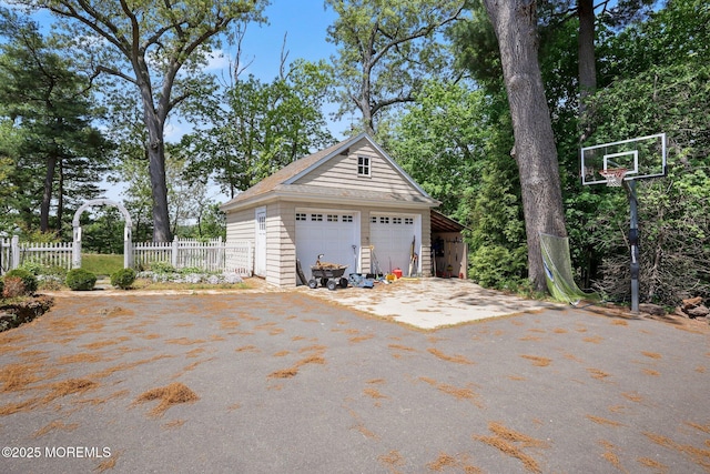 garage with a garage and fence