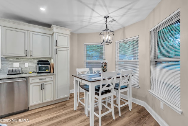 578 Petunia Ln N, Whiting, NJ 08759 - dining area featuring a chandelier, light wood-style floors, and baseboards