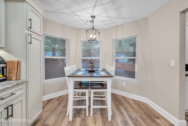 578 Petunia Ln N, Whiting, NJ 08759 - dining area featuring light wood-type flooring, a chandelier, and baseboards