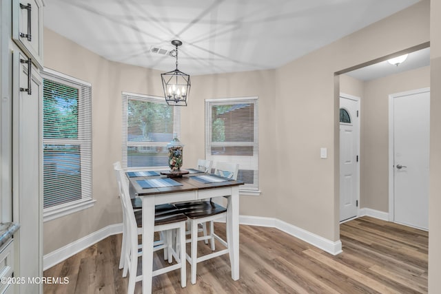 578 Petunia Ln N, Whiting, NJ 08759 - dining area featuring a chandelier, baseboards, light wood finished floors, and healthy amount of natural light