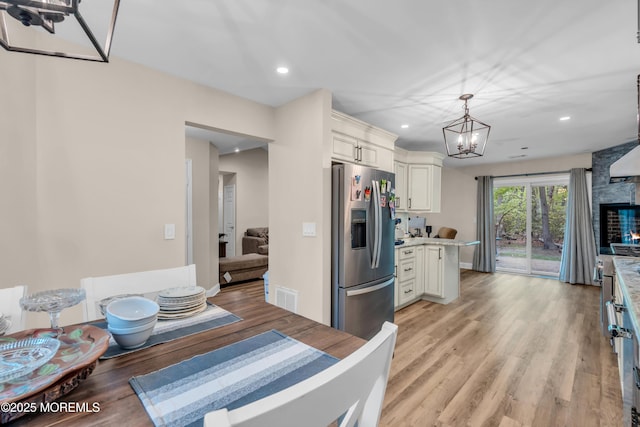 578 Petunia Ln N, Whiting, NJ 08759 - kitchen with stainless steel fridge with ice dispenser, a chandelier, light countertops, light wood finished floors, and recessed lighting