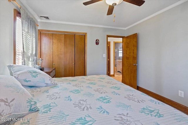 bedroom with a closet, crown molding, a ceiling fan, and baseboards
