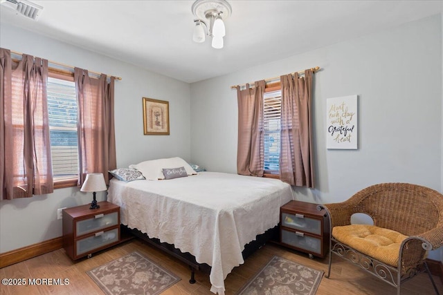 bedroom with wood finished floors and baseboards