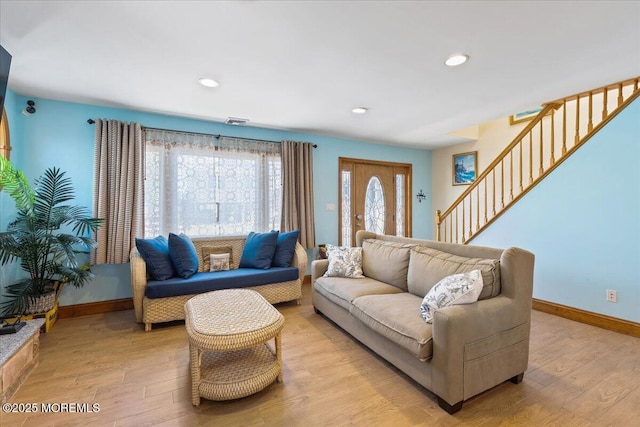 living room with baseboards, light wood-style flooring, stairs, and recessed lighting
