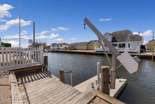 dock area with a water view and a residential view