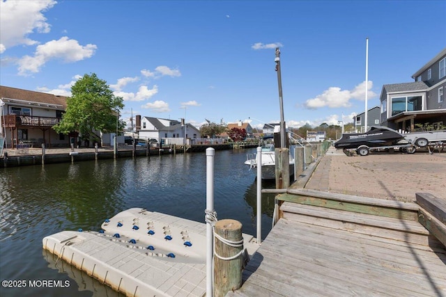 dock featuring a water view and a residential view