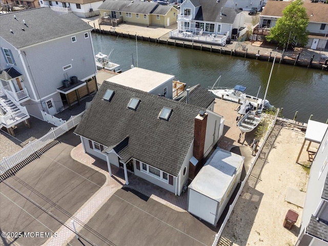 aerial view of residential area featuring a large body of water