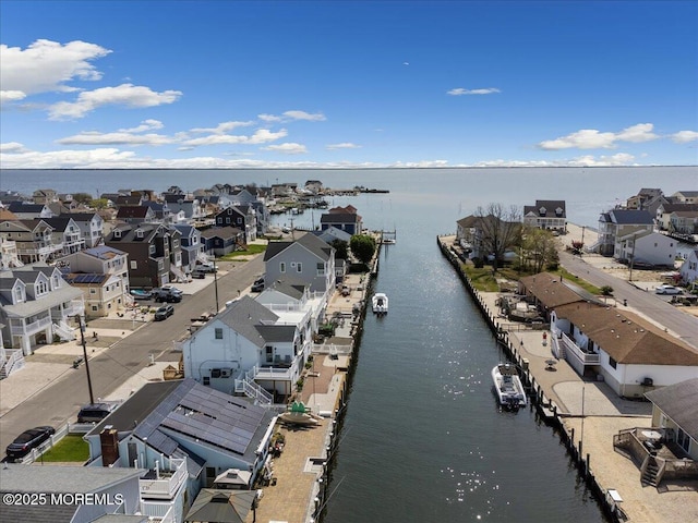 aerial view of residential area featuring a nearby body of water