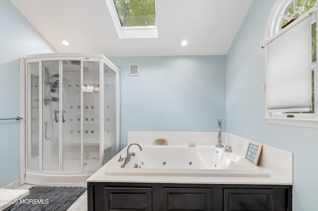 bathroom featuring a shower stall, a skylight, a whirlpool tub, and recessed lighting