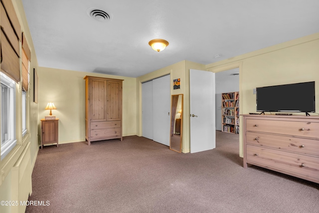 carpeted bedroom featuring a closet