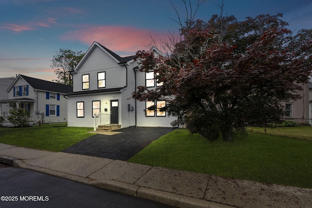 view of front facade featuring asphalt driveway