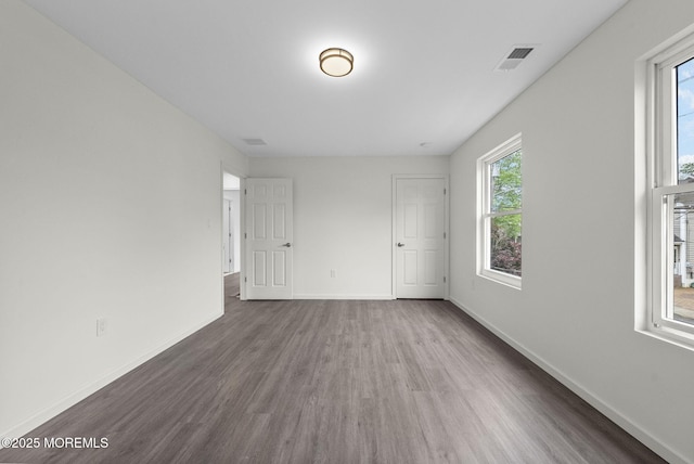 unfurnished room featuring wood finished floors and baseboards