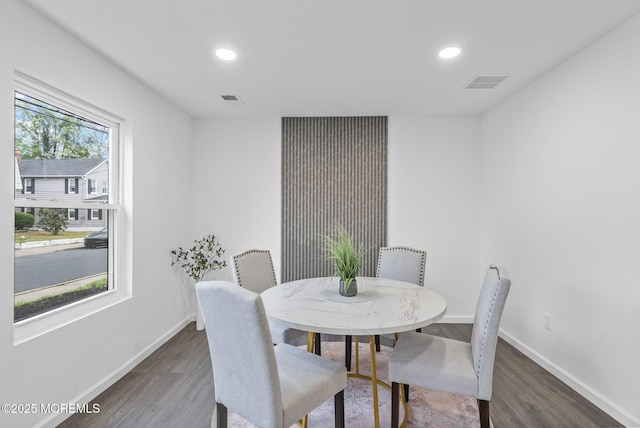 dining space with wood finished floors, baseboards, and recessed lighting