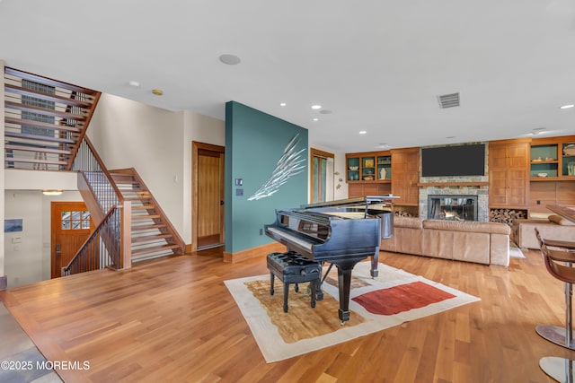 154 Ocean Blvd, Atlantic Highlands, NJ 07716 - rec room with a glass covered fireplace, wood finished floors, recessed lighting, and baseboards