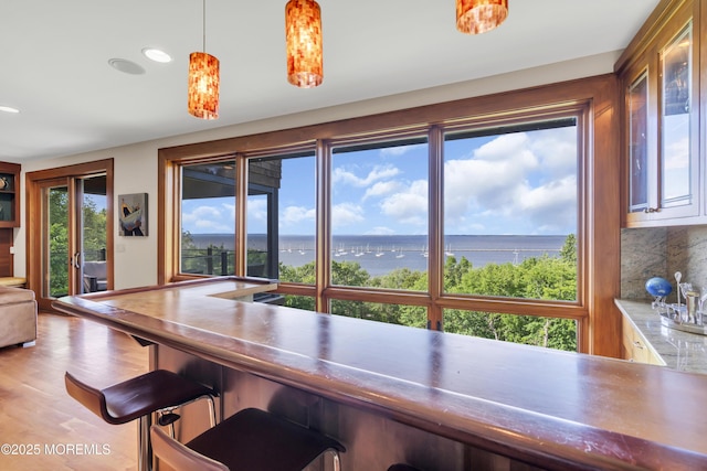 154 Ocean Blvd, Atlantic Highlands, NJ 07716 - dining space with a water view, light wood-type flooring, recessed lighting, and bar area