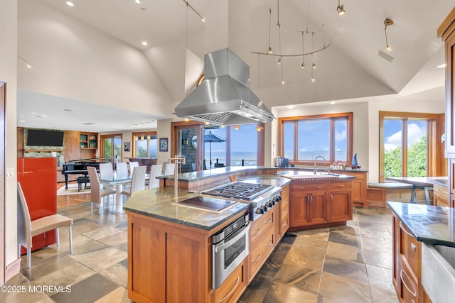 154 Ocean Blvd, Atlantic Highlands, NJ 07716 - kitchen with island exhaust hood, stainless steel appliances, brown cabinets, recessed lighting, and dark stone countertops