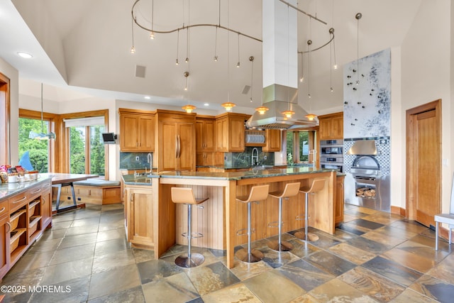 154 Ocean Blvd, Atlantic Highlands, NJ 07716 - kitchen featuring a high ceiling, decorative backsplash, brown cabinets, recessed lighting, and stone tile flooring