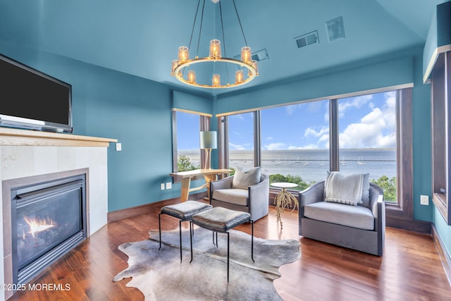 154 Ocean Blvd, Atlantic Highlands, NJ 07716 - living room featuring a chandelier, a tiled fireplace, wood finished floors, and baseboards