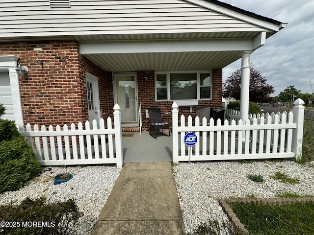 1 Lagos Ct, Toms River, NJ 08757 - property entrance featuring a porch and brick siding