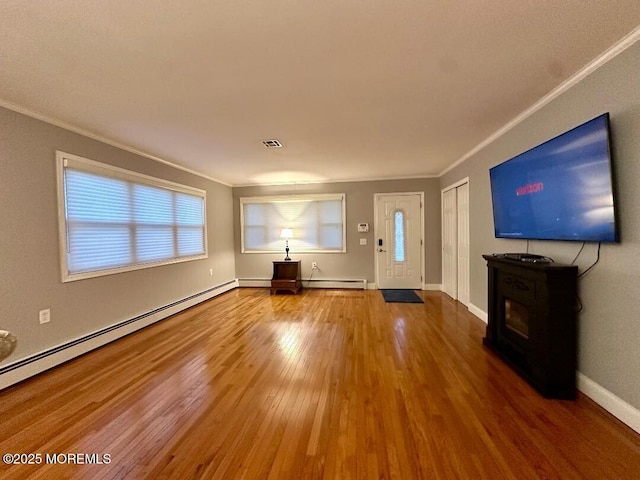 1 Lagos Ct, Toms River, NJ 08757 - unfurnished living room featuring ornamental molding, wood finished floors, and a baseboard radiator