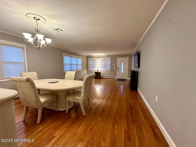 1 Lagos Ct, Toms River, NJ 08757 - dining space with crown molding, a chandelier, hardwood / wood-style floors, baseboard heating, and a baseboard heating unit