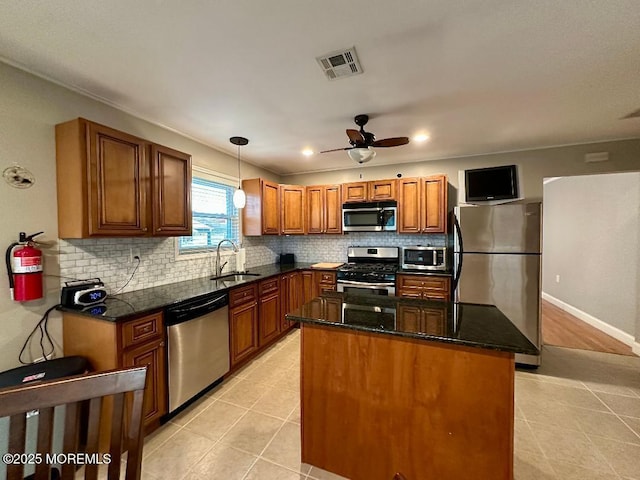 1 Lagos Ct, Toms River, NJ 08757 - kitchen with appliances with stainless steel finishes, light tile patterned floors, brown cabinets, backsplash, and recessed lighting