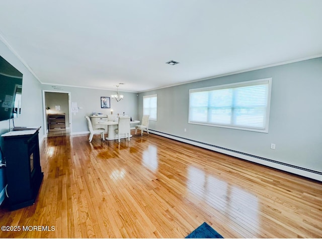 1 Lagos Ct, Toms River, NJ 08757 - living area with hardwood / wood-style flooring, ornamental molding, a chandelier, a baseboard radiator, and a wood stove