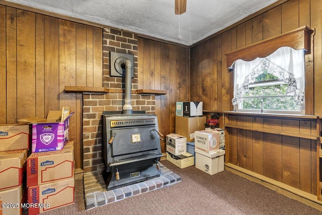 1601 Chestnut Ave, Ocean Twp, NJ 07712 - miscellaneous room with a wood stove, carpet flooring, wooden walls, and ceiling fan