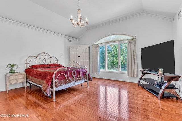 bedroom featuring vaulted ceiling, a chandelier, ornamental molding, light wood finished floors, and baseboards