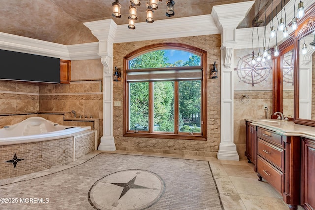 full bathroom featuring ornamental molding, a chandelier, a bath, and vanity