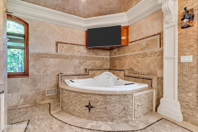 bathroom with a whirlpool tub, ornamental molding, tile patterned floors, and tile walls