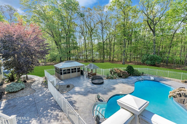 view of swimming pool featuring a fire pit and a patio area
