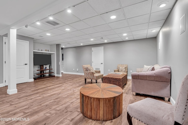 sitting room with light wood-style flooring, baseboards, and recessed lighting