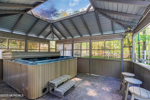 sunroom / solarium with a jacuzzi and lofted ceiling