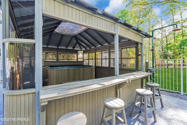 view of patio featuring a hot tub and a gazebo