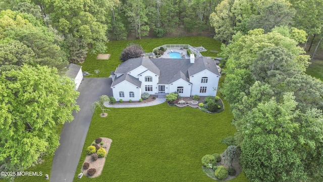 view from above of property with a heavily wooded area