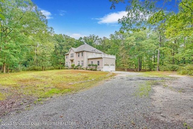 2557 Huckleberry Rd, Manchester, NJ 08759 - view of front of property featuring an attached garage, a wooded view, and gravel driveway
