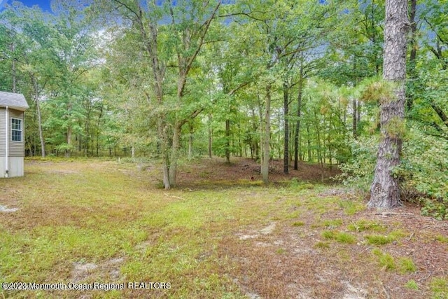 2557 Huckleberry Rd, Manchester, NJ 08759 - view of yard with a wooded view