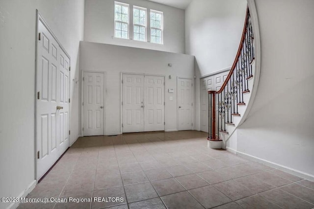 2557 Huckleberry Rd, Manchester, NJ 08759 - tiled foyer featuring a high ceiling, stairs, and baseboards