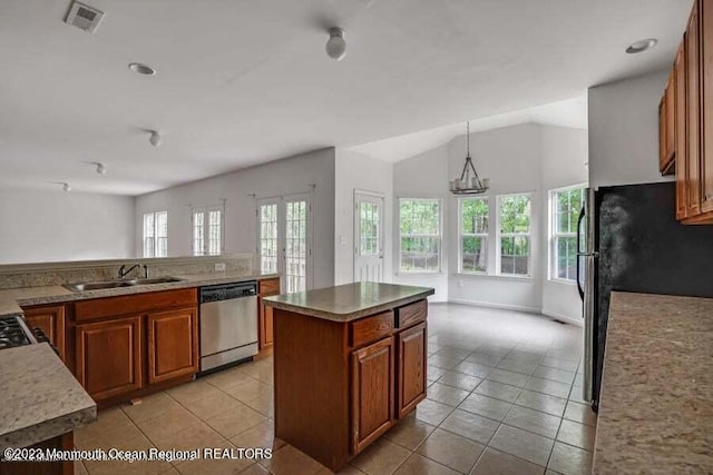 2557 Huckleberry Rd, Manchester, NJ 08759 - kitchen with stainless steel appliances, a sink, light tile patterned floors, brown cabinetry, and a kitchen island