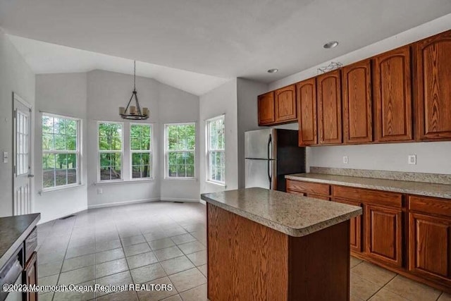 2557 Huckleberry Rd, Manchester, NJ 08759 - kitchen featuring appliances with stainless steel finishes, light tile patterned floors, plenty of natural light, a center island, and vaulted ceiling