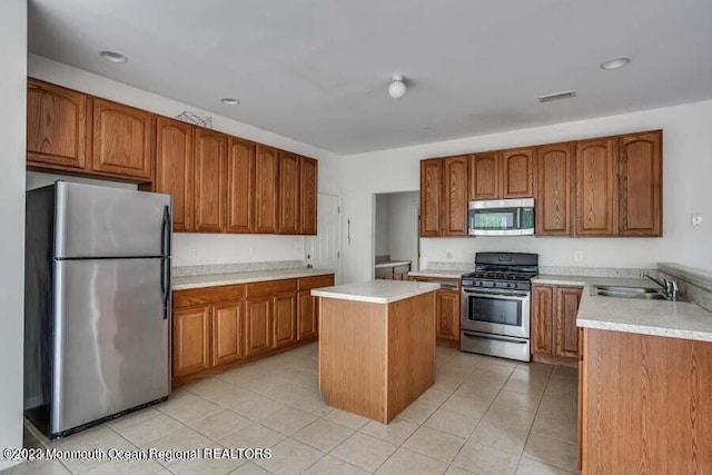 2557 Huckleberry Rd, Manchester, NJ 08759 - kitchen with stainless steel appliances, brown cabinets, a sink, light tile patterned floors, and recessed lighting